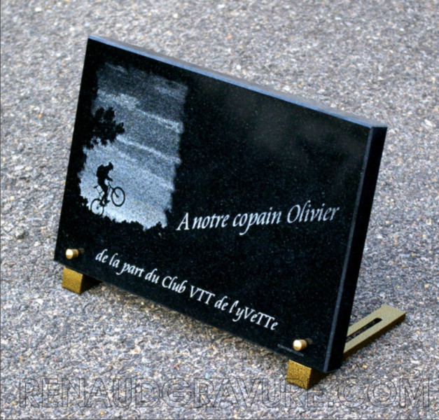 Engraving of a bicycle on a granite plaque